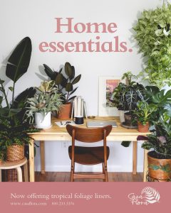 Casa Flora's Home Essentials ad displaying our tropical foliage products around a home office. Call 800-233-3376 to order.